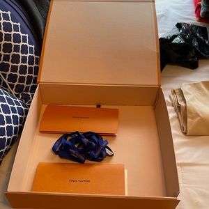 Louis Vuitton box, ribbon and paperwork